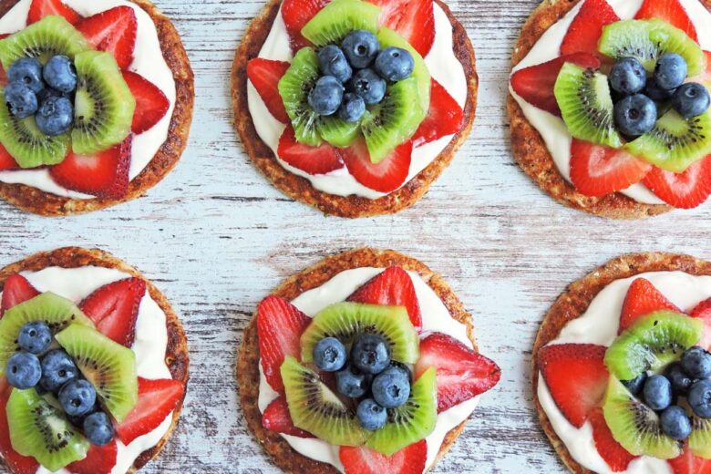 Mini fruit pizzas with strawberry, kiwi, and blueberries littleeatsandthings.com