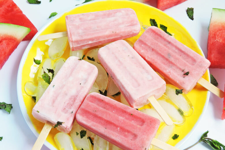 Creamy Watermelon and Mint Popsicles on a yellow plate