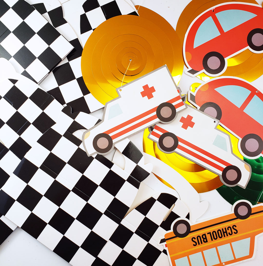 DIY Race Car Party Favor Boxes with black and white checkerboard boxes with cars glued to the front