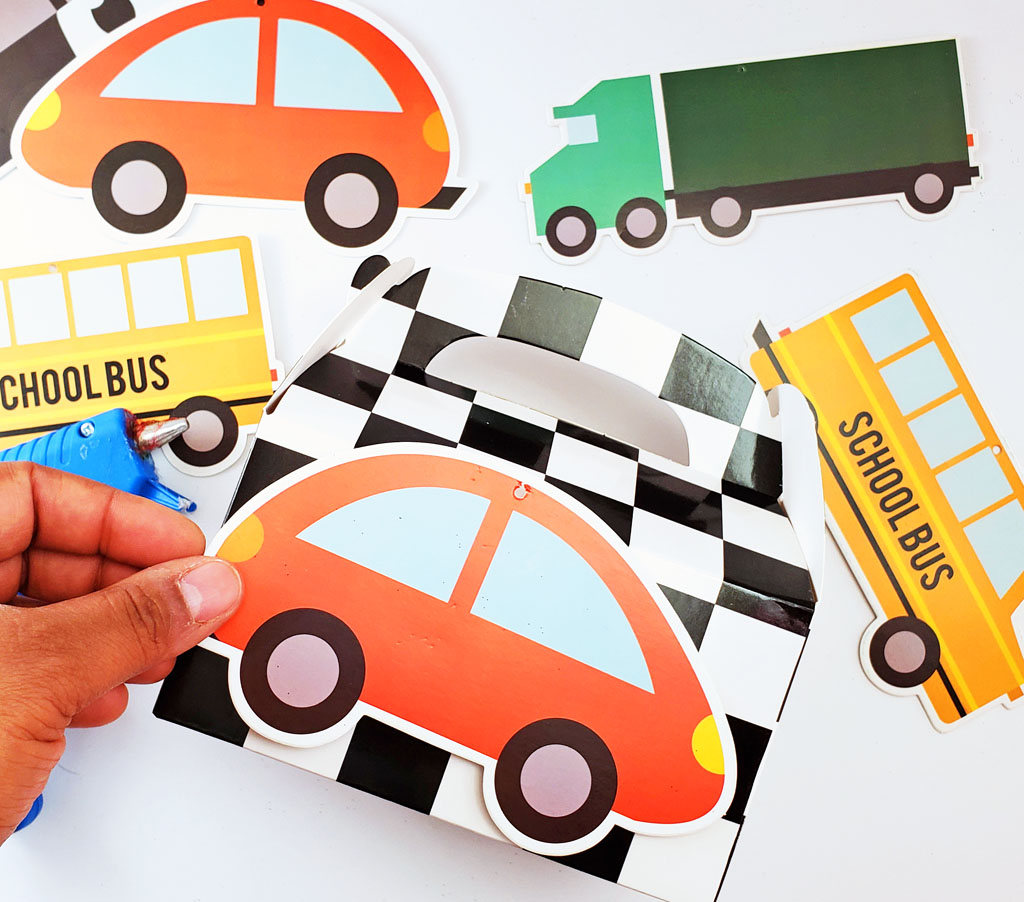 DIY Race Car Party Favor Boxes with black and white checkerboard boxes with cars glued to the front