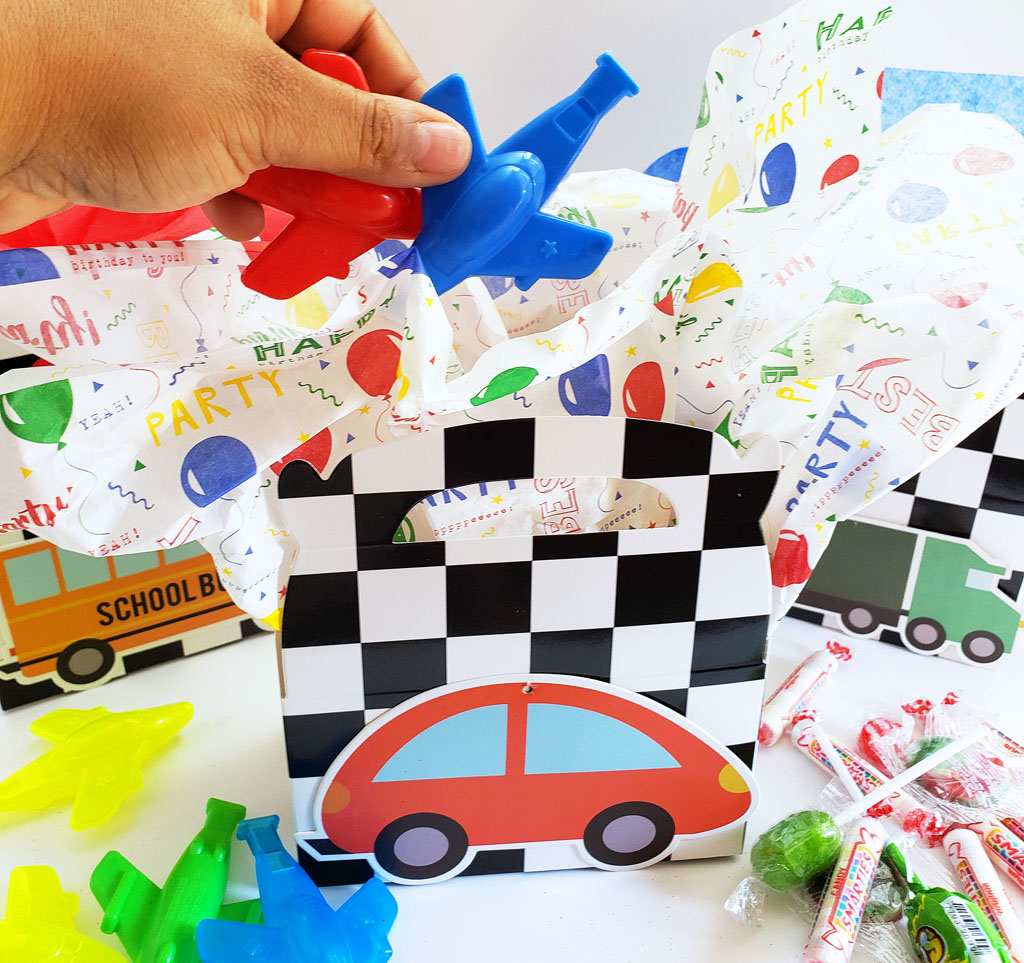 DIY Race Car Party Favor Boxes with black and white checkerboard boxes with cars glued to the front