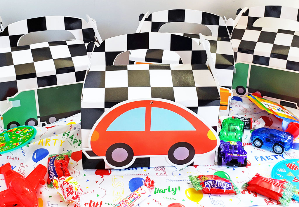 DIY Race Car Party Favor Boxes with black and white checkerboard boxes with cars glued to the front