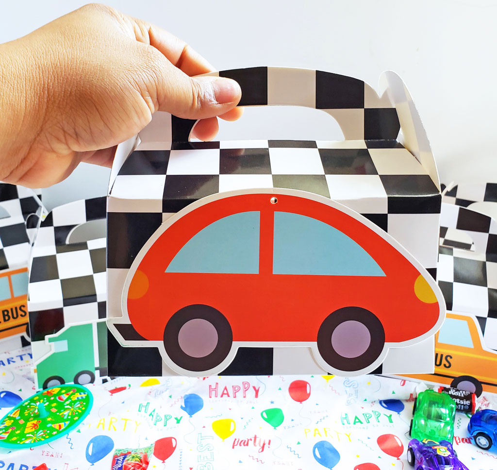 DIY Race Car Party Favor Boxes with black and white checkerboard boxes with cars glued to the front