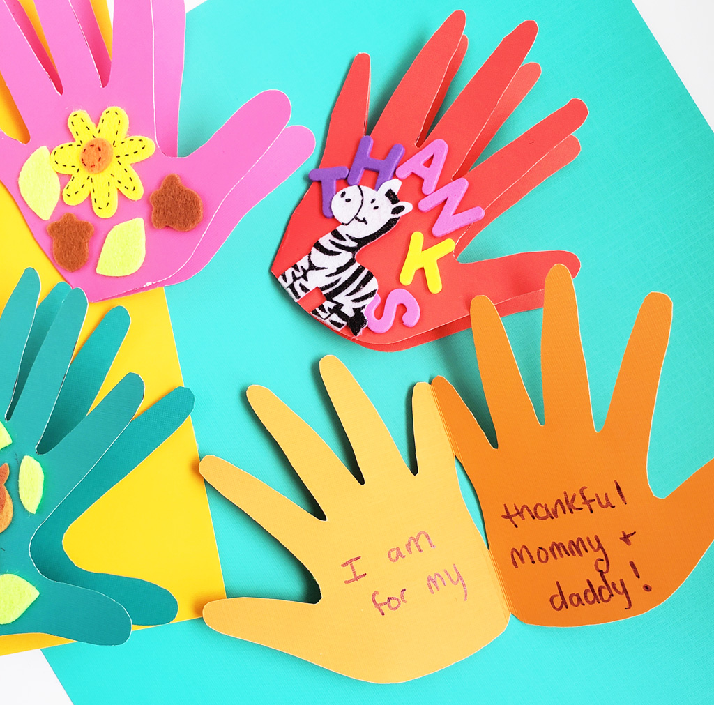 Easy DIY Thanksgiving Cards made with hand prints and stickers on colored craft paper. Perfect for teachers and parents. #thanksgivingcrafts #diythanksgiving