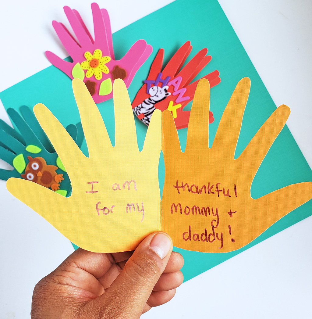 Easy DIY Thanksgiving Cards made with hand prints and stickers on colored craft paper. Perfect for teachers and parents. #thanksgivingcrafts #diythanksgiving