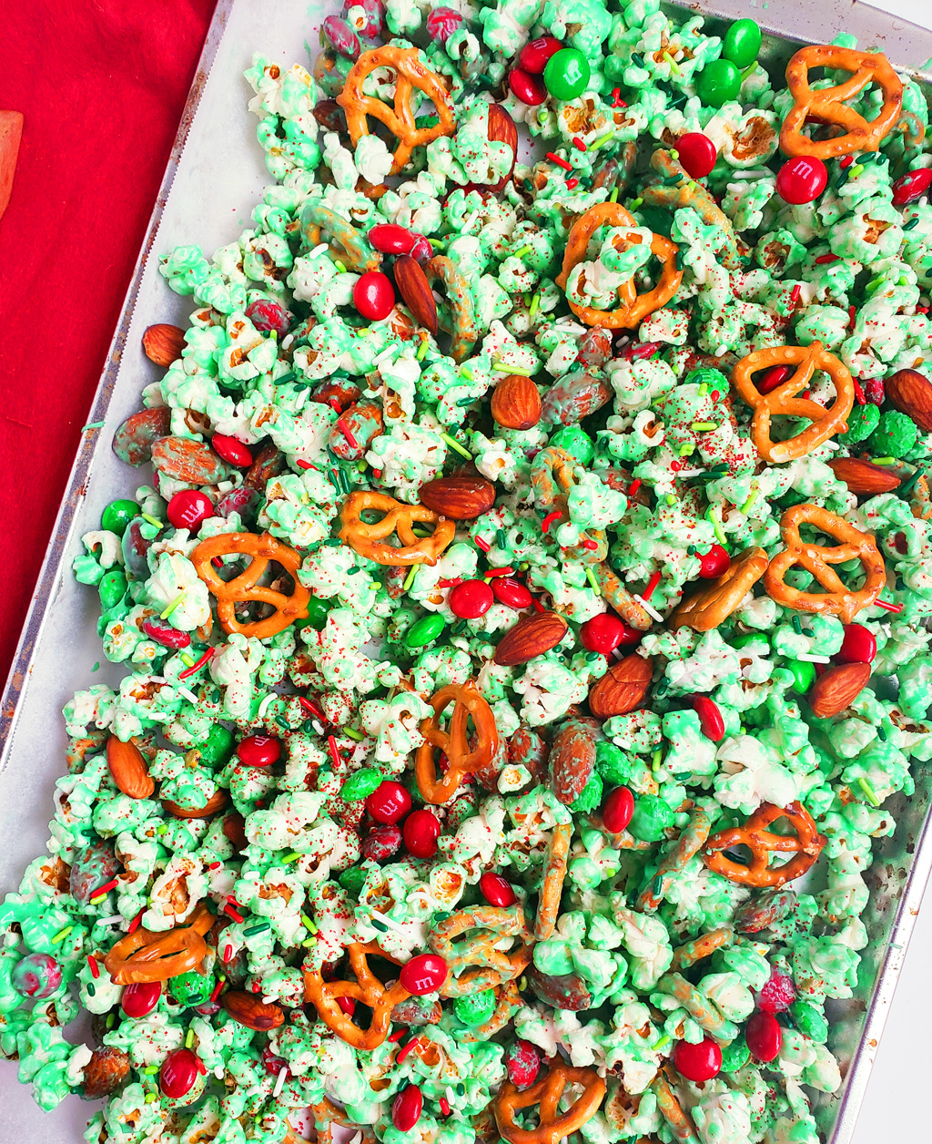 Easy Holiday Grinch Mix made with green white chocolate, almonds, pretzels, and M&Ms