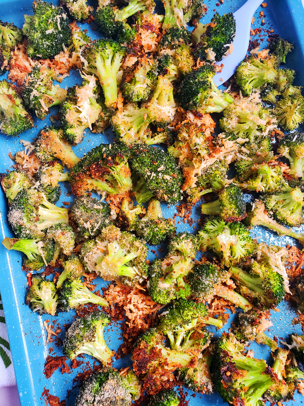 Quick & Easy Parmesan Roasted Broccoli on a blue sheet pan