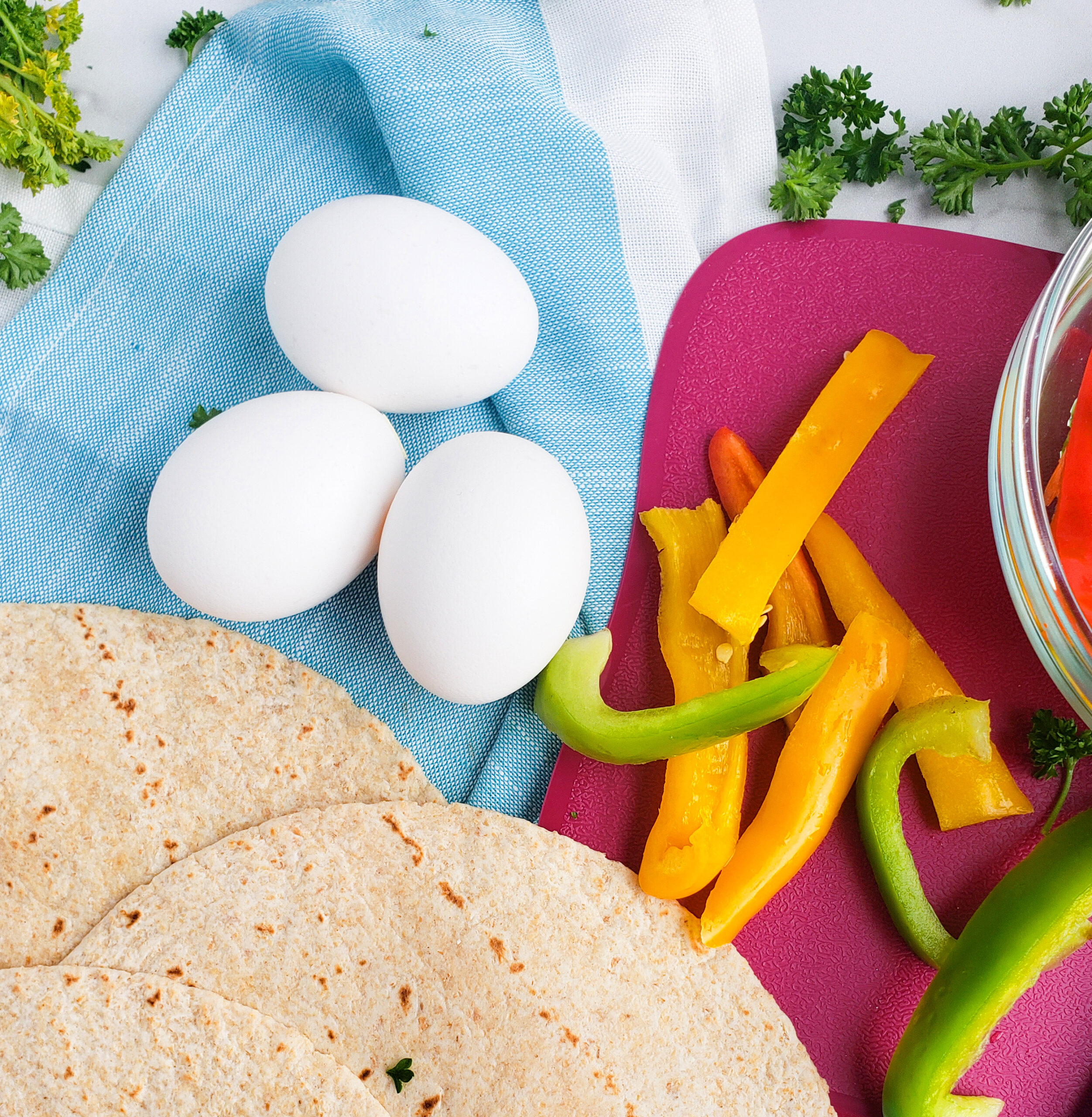 Cheesy Veggie & Egg Breakfast Roll-Ups, the perfect kid-approved, toddler-approved meal. #healthykids #kidsinthekitchen #breakfastwraps