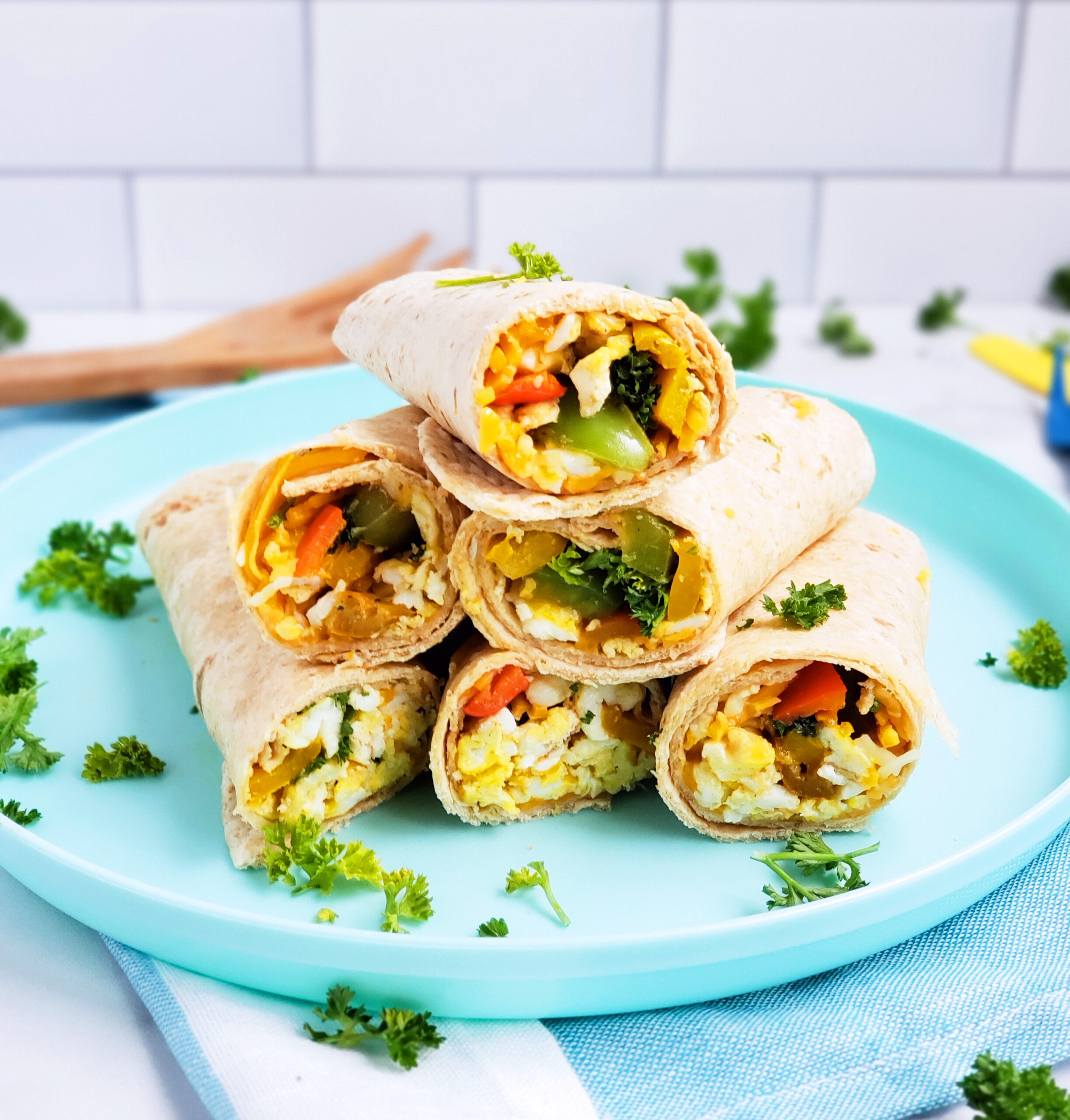 Cheesy Veggie & Egg Breakfast Roll-Ups, the perfect kid-approved, toddler-approved meal. #healthykids #kidsinthekitchen #breakfastwraps