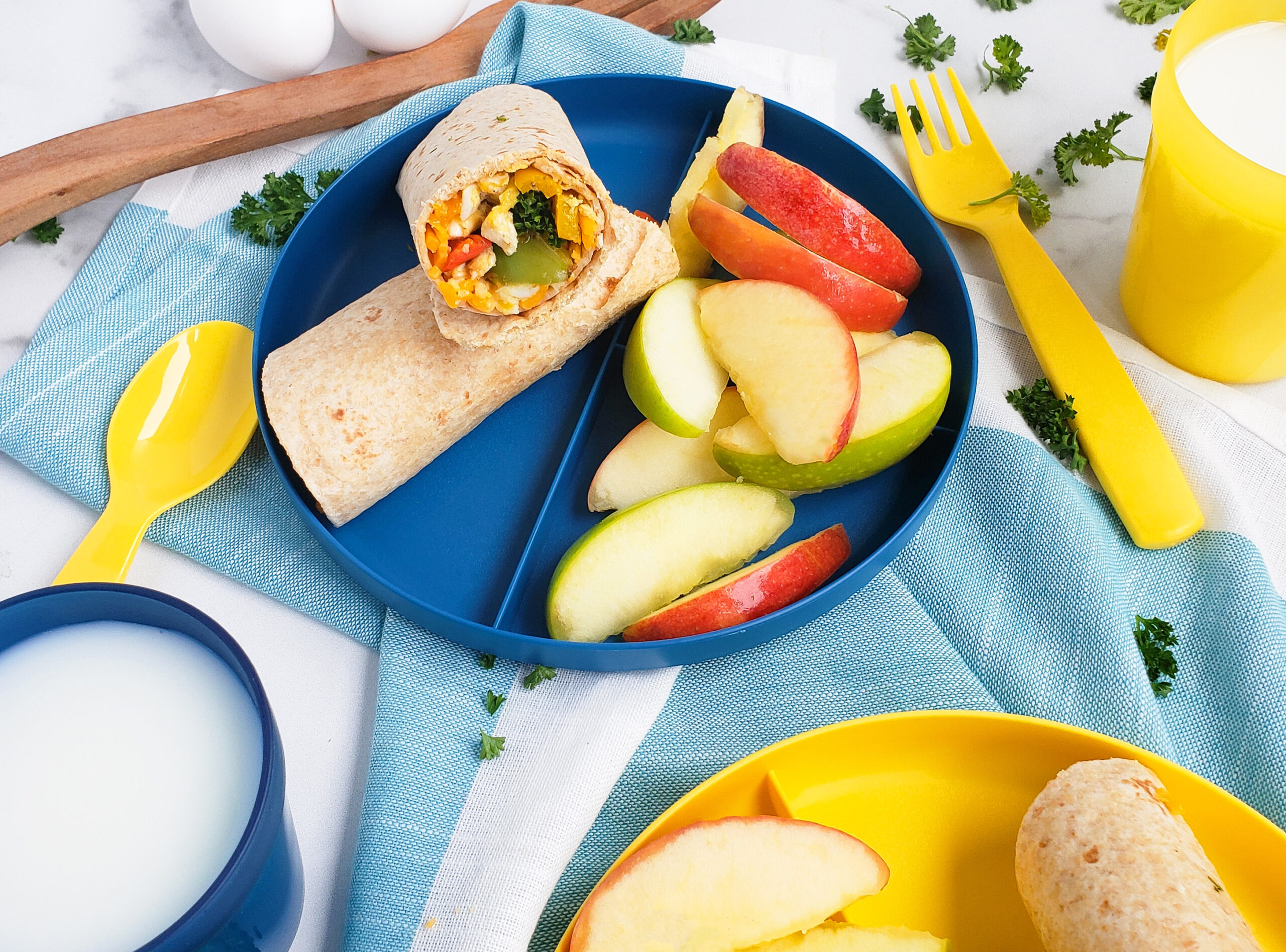 Cheesy Veggie & Egg Breakfast Roll-Ups, the perfect kid-approved, toddler-approved meal. #healthykids #kidsinthekitchen #breakfastwraps