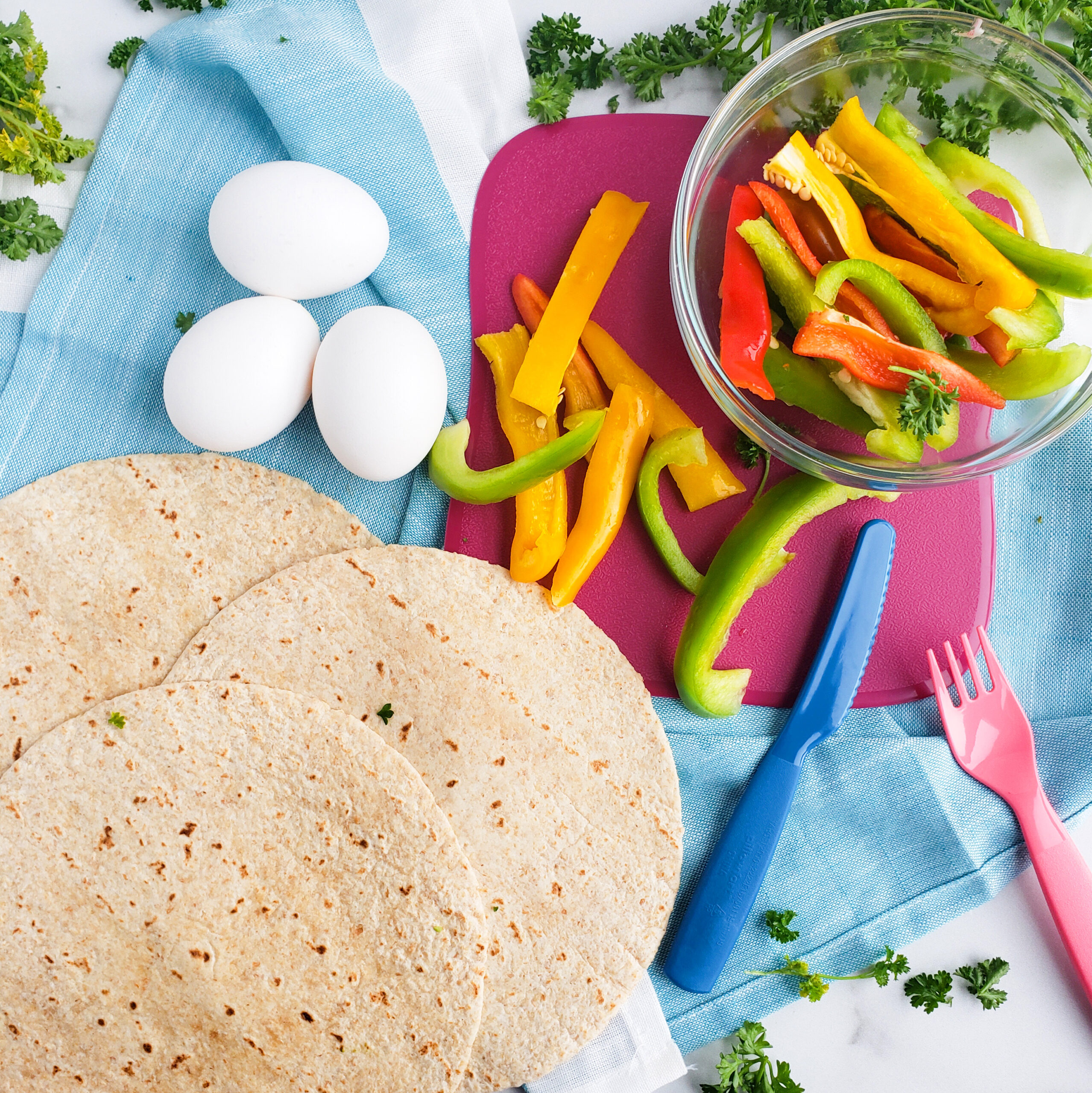 Cheesy Veggie & Egg Breakfast Roll-Ups, the perfect kid-approved, toddler-approved meal. #healthykids #kidsinthekitchen #breakfastwraps