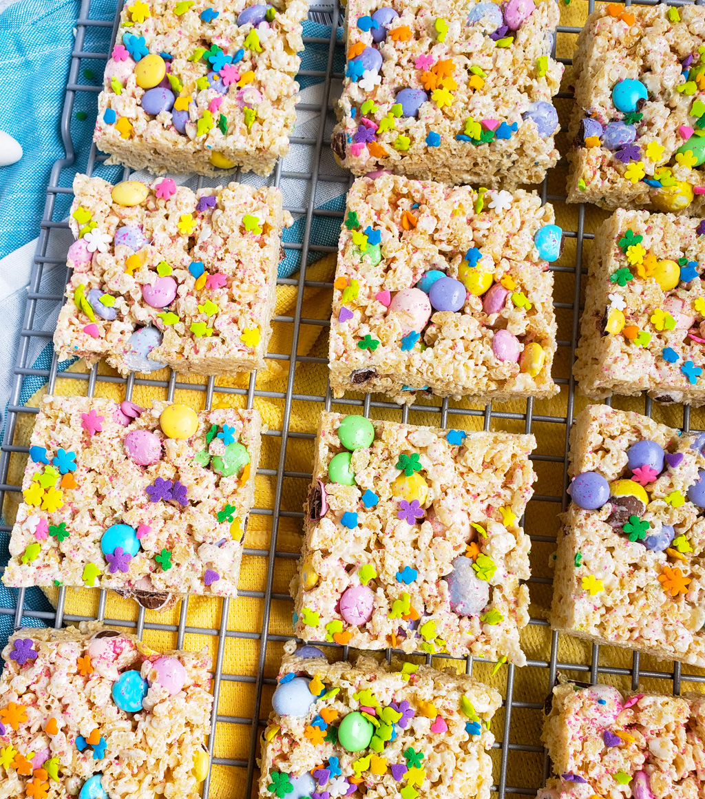 The Best Easter Rice Krispies Treats made with M&Ms, Cadbury eggs, and sprinkles. Cut into squares on a wire rack. The perfect Spring treats