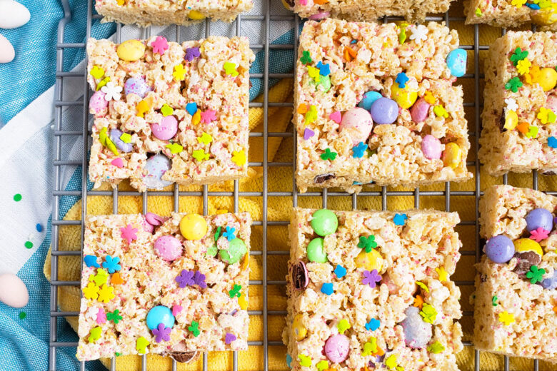 The Best Easter Rice Krispies Treats made with M&Ms, Cadbury eggs, and sprinkles. Cut into squares on a wire rack. The perfect Spring treat