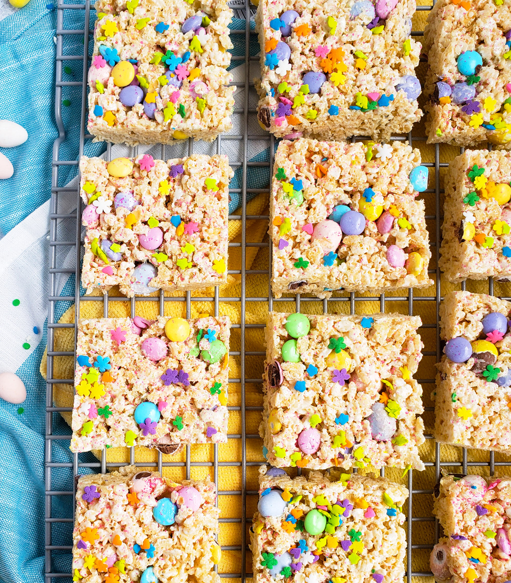 The Best Easter Rice Krispies Treats made with M&Ms, Cadbury eggs, and sprinkles. Cut into squares on a wire rack. The perfect Spring treat