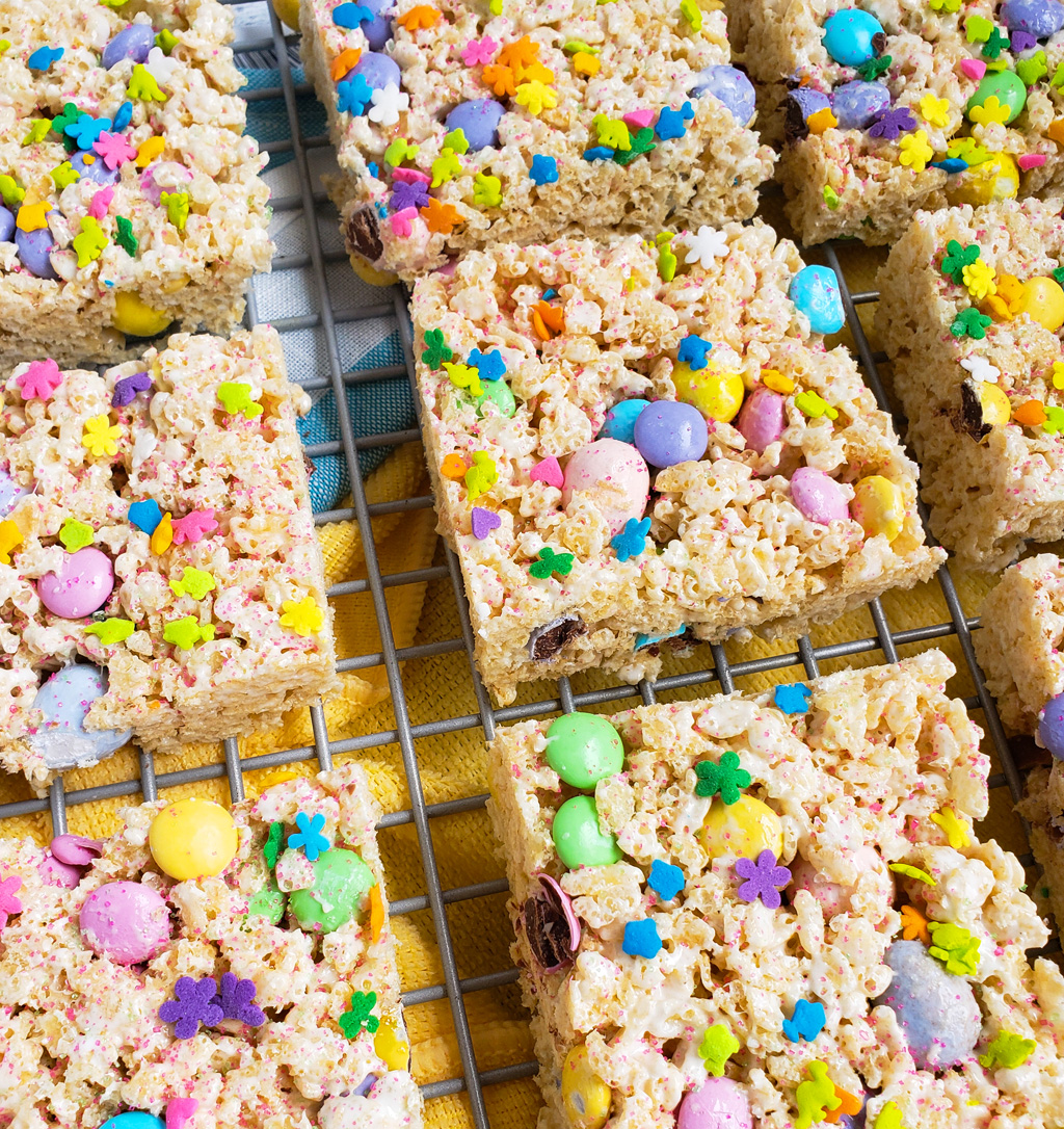 The Best Easter Rice Krispies Treats made with M&Ms, Cadbury eggs, and sprinkles. Cut into squares on a wire rack. The perfect Spring treats