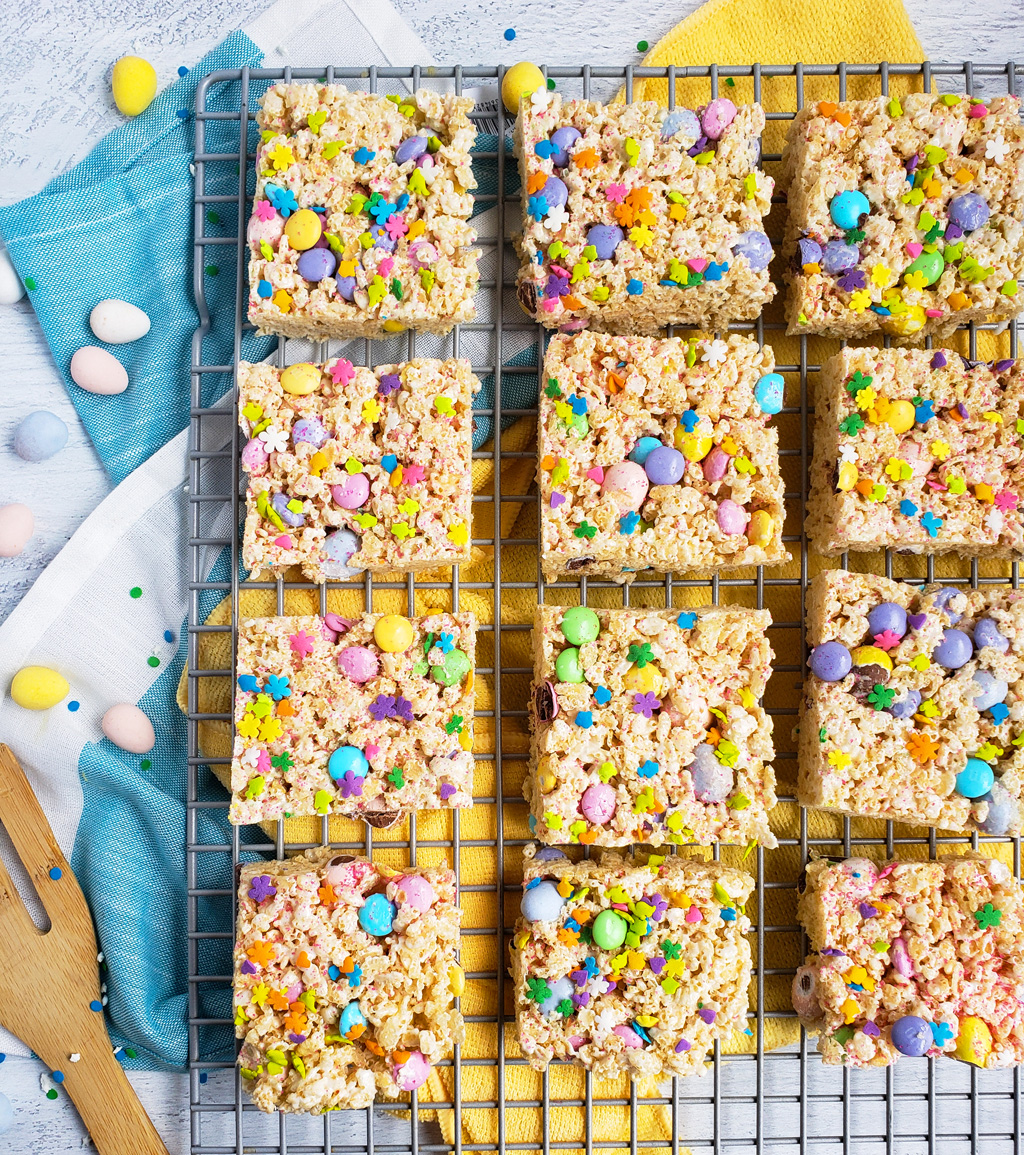 The Best Easter Rice Krispies Treats made with M&Ms, Cadbury eggs, and sprinkles. Cut into squares on a wire rack. The perfect Spring treats