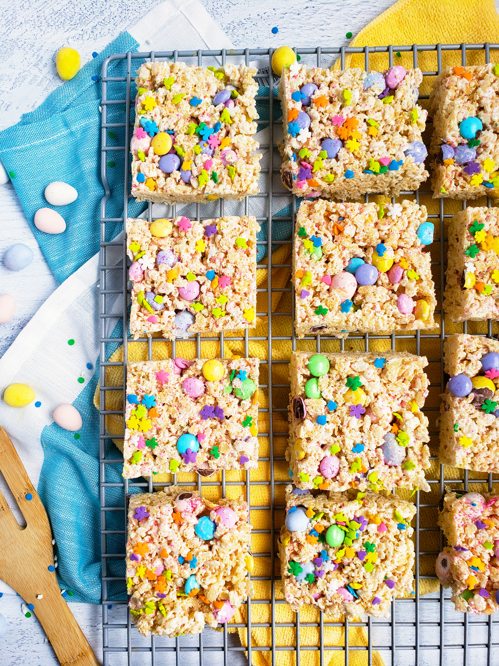 The Best Easter Rice Krispies Treats made with M&Ms, Cadbury eggs, and sprinkles. Cut into squares on a wire rack. The perfect Spring treat