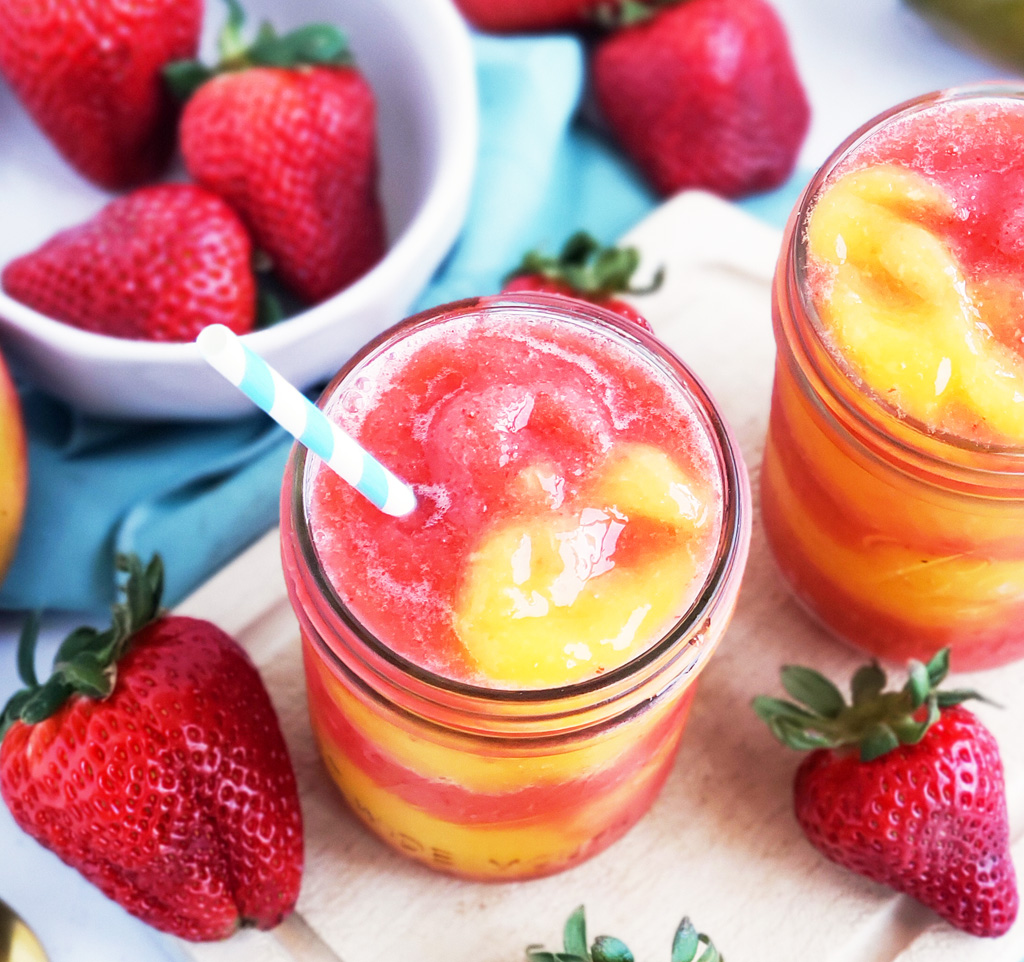 Fresh Mango Strawberry Swirled Slushies. Summer is almost here, so let’s celebrate with these Fresh Mango Strawberry Swirled Slushies, made with fresh mangos (mangoes) and strawberries, and sweetened with a touch of honey. #slush #slushies #fruitslushies #frozentreats #healthytreatsforkids #kidapproved littleeatsandthings.com