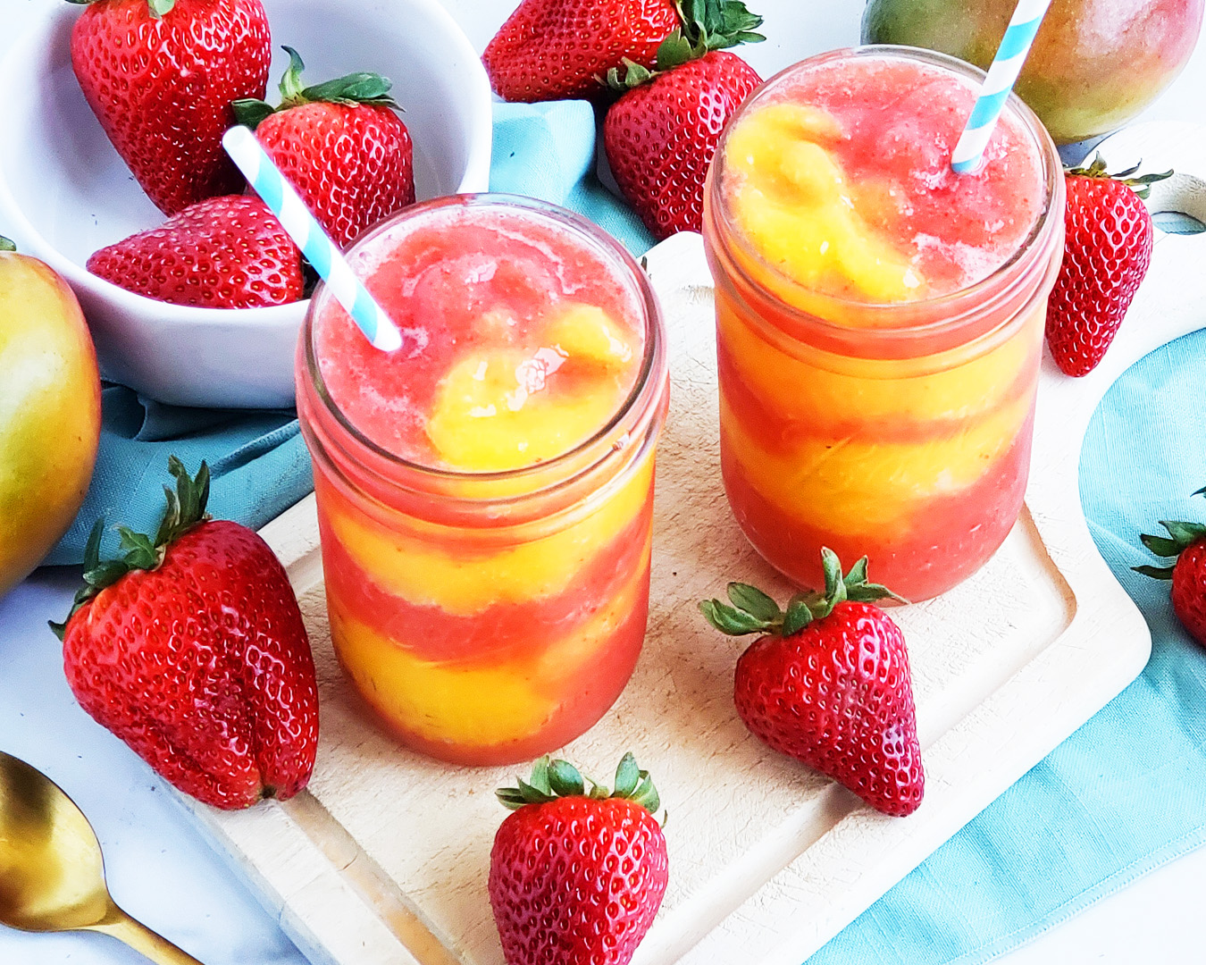 Fresh Mango Strawberry Swirled Slushies. Summer is almost here, so let’s celebrate with these Fresh Mango Strawberry Swirled Slushies, made with fresh mangos (mangoes) and strawberries, and sweetened with a touch of honey. #slush #slushies #fruitslushies #frozentreats #healthytreatsforkids #kidapproved littleeatsandthings.com