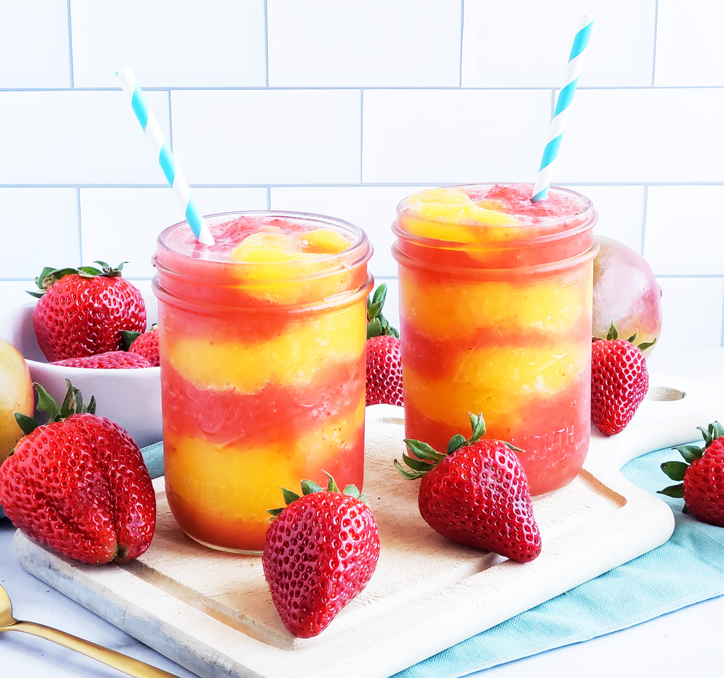 Fresh Mango Strawberry Swirled Slushies. Summer is almost here, so let’s celebrate with these Fresh Mango Strawberry Swirled Slushies, made with fresh mangos (mangoes) and strawberries, and sweetened with a touch of honey. #slush #slushies #fruitslushies #frozentreats #healthytreatsforkids #kidapproved littleeatsandthings.com