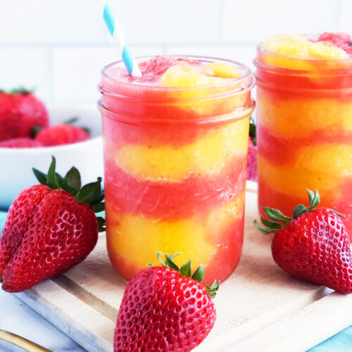 Fresh Mango Strawberry Swirled Slushies. Summer is almost here, so let’s celebrate with these Fresh Mango Strawberry Swirled Slushies, made with fresh mangos (mangoes) and strawberries, and sweetened with a touch of honey. #slush #slushies #fruitslushies #frozentreats #healthytreatsforkids #kidapproved littleeatsandthings.com