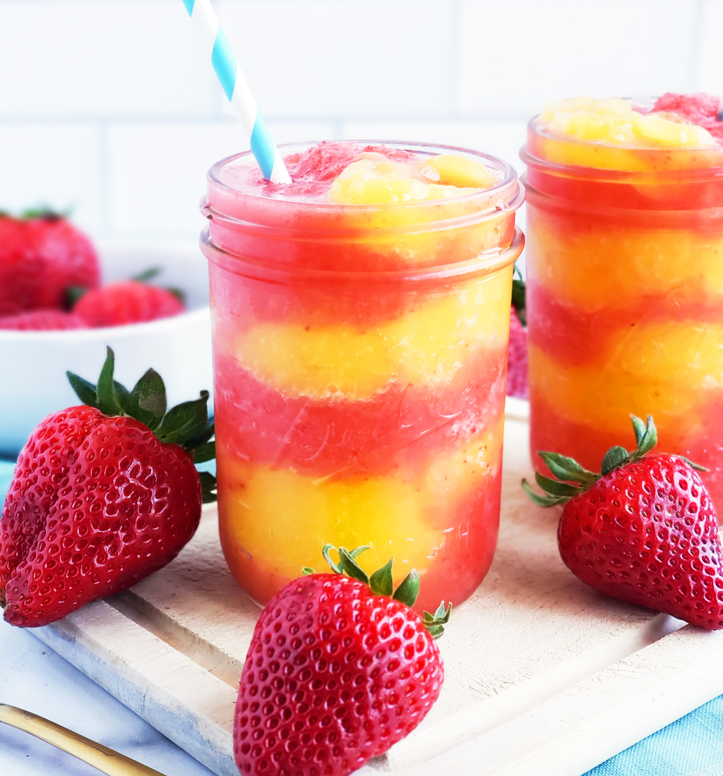 Fresh Mango Strawberry Swirled Slushies. Summer is almost here, so let’s celebrate with these Fresh Mango Strawberry Swirled Slushies, made with fresh mangos (mangoes) and strawberries, and sweetened with a touch of honey. #slush #slushies #fruitslushies #frozentreats #healthytreatsforkids #kidapproved littleeatsandthings.com