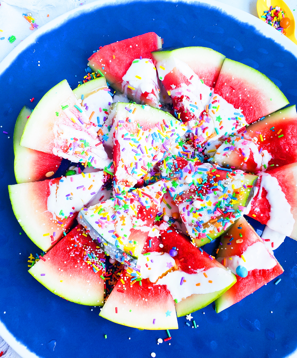 Fun & Easy Sweet Watermelon Nachos made with vanilla Greek yogurt, honey, and sprinkles. The perfect summer treat, also great for the 4th of July. Littleeatsandthings.com