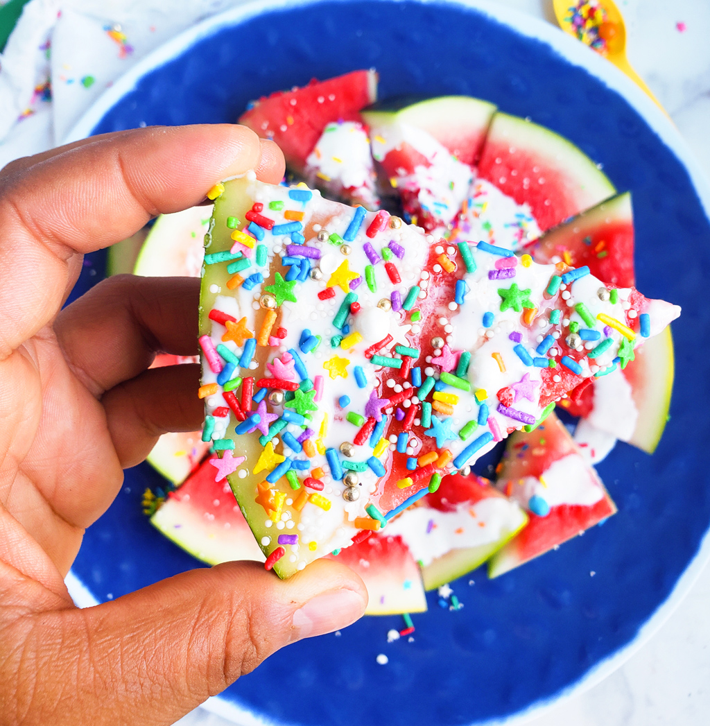 Fun & Easy Sweet Watermelon Nachos made with vanilla Greek yogurt, honey, and sprinkles. The perfect summer treat, also great for the 4th of July. Littleeatsandthings.com