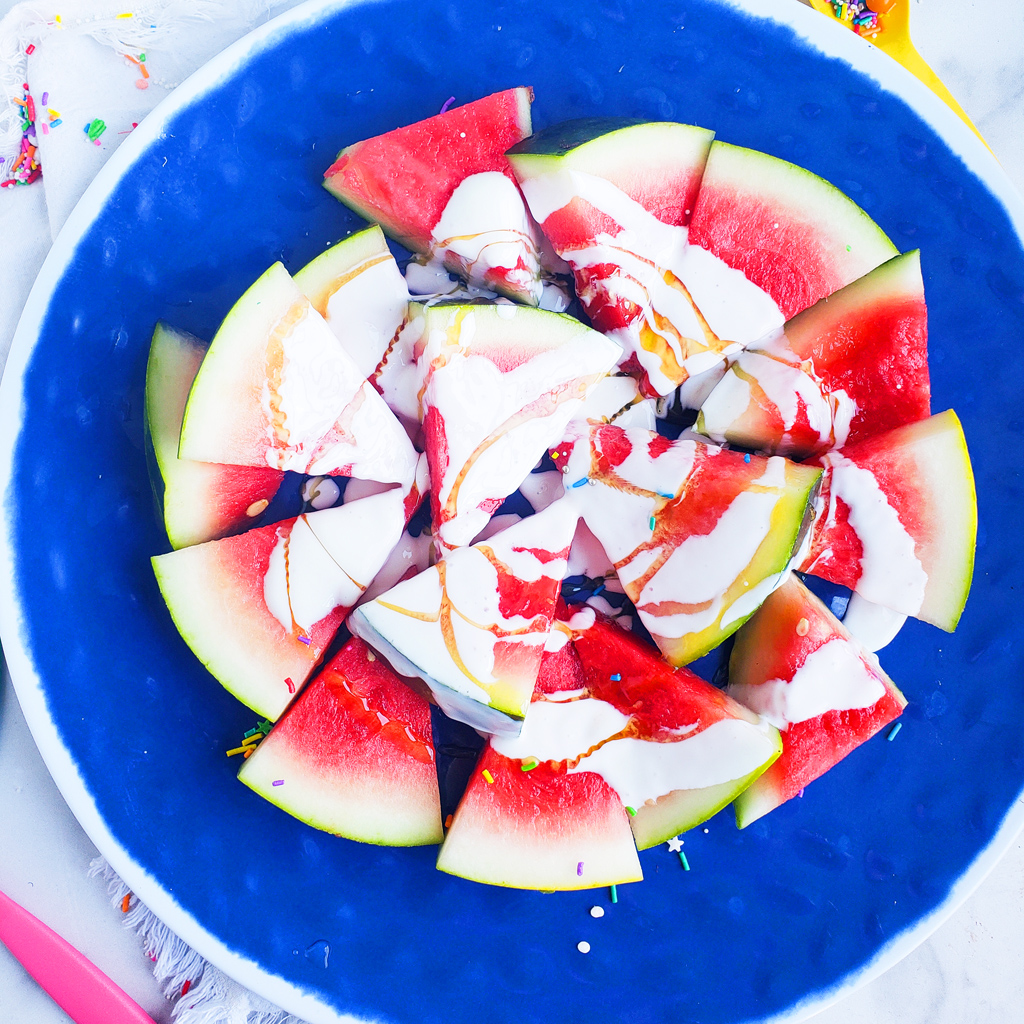 Fun & Easy Sweet Watermelon Nachos made with vanilla Greek yogurt, honey, and sprinkles. The perfect summer treat, also great for the 4th of July. Littleeatsandthings.com