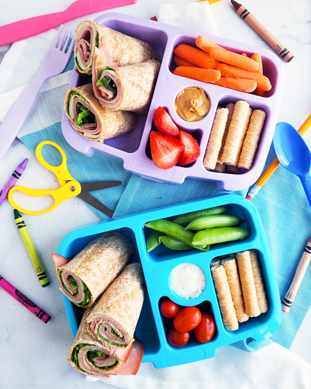 Bento box filled and arranged beautifully with fruits, veggies, whole wheat ham and cheese wraps. Healthy bento lunch ideas for kids. Littleeatsandthings.com