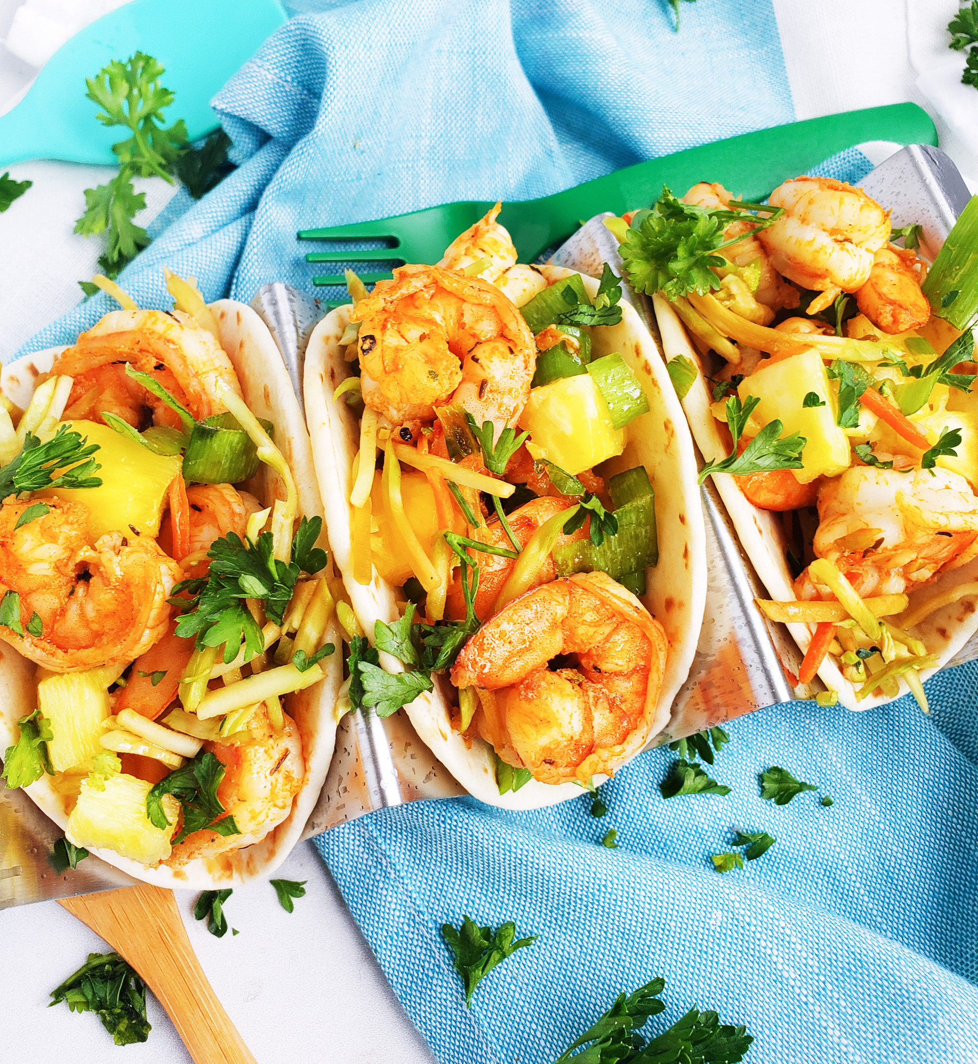 These Spicy Jerk Shrimp Mini Tacos are loaded with so much flavor and super easy to make! These street tacos are piled high with marinated slaw, jerk shrimp, pineapple, and green onions. Littleeatsandthings.com