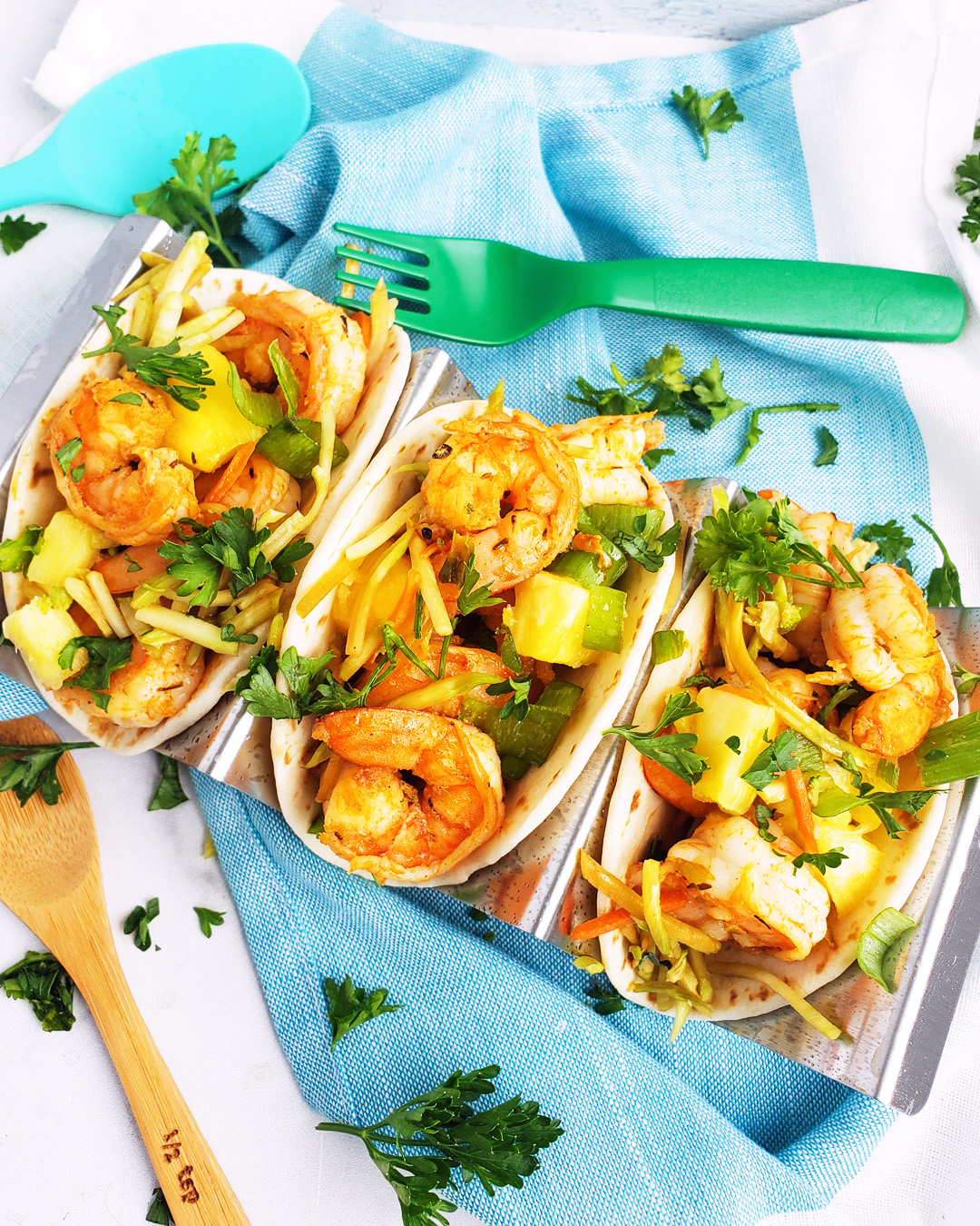 These Spicy Jerk Shrimp Mini Tacos are loaded with so much flavor and super easy to make! These street tacos are piled high with marinated slaw, jerk shrimp, pineapple, and green onions. Littleeatsandthings.com