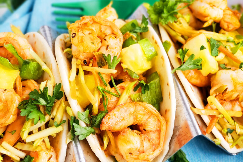 These Spicy Jerk Shrimp Mini Tacos are loaded with so much flavor and super easy to make! These street tacos are piled high with marinated slaw, jerk shrimp, pineapple, and green onions. Littleeatsandthings.com