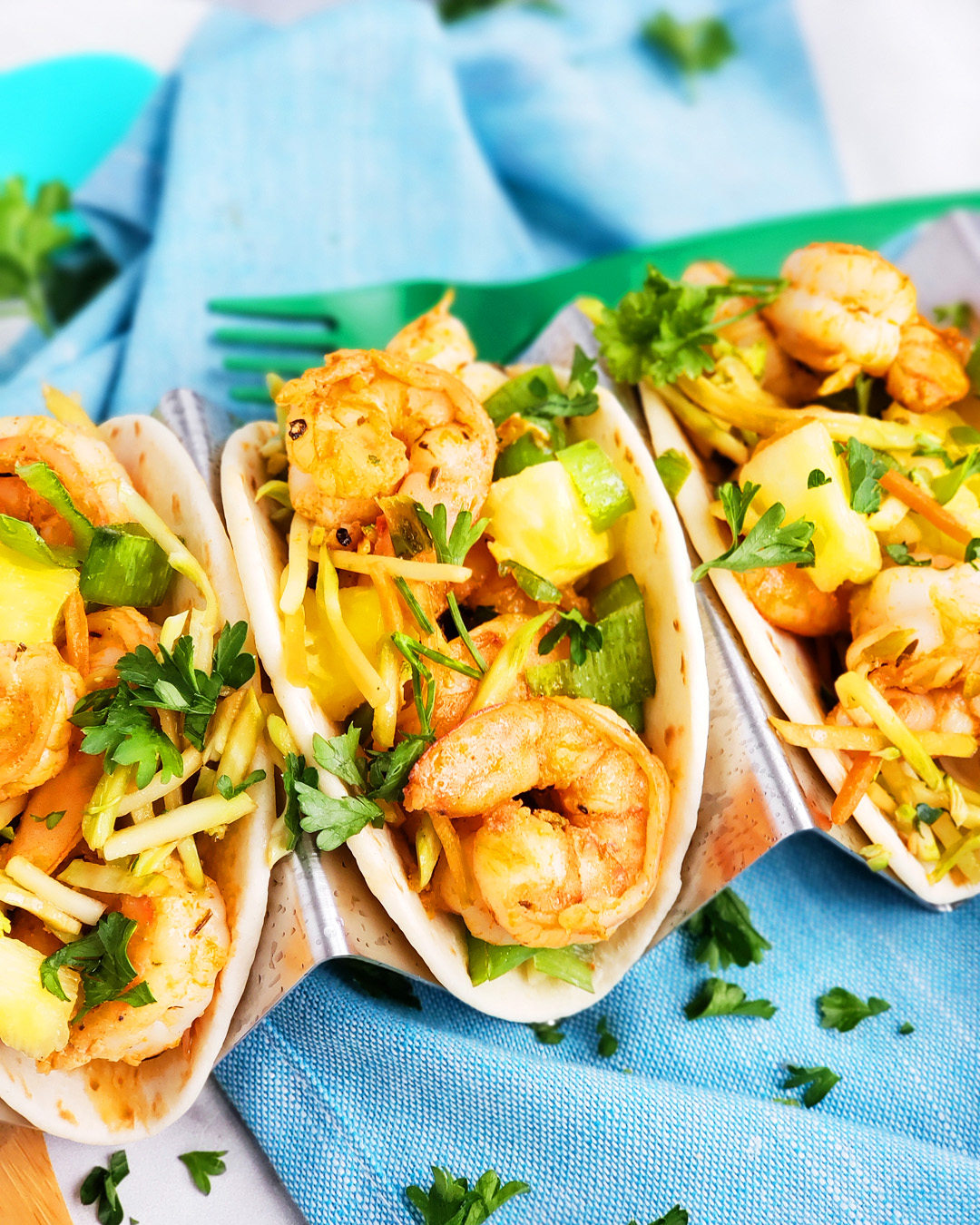 These Spicy Jerk Shrimp Mini Tacos are loaded with so much flavor and super easy to make! These street tacos are piled high with marinated slaw, jerk shrimp, pineapple, and green onions. Littleeatsandthings.com