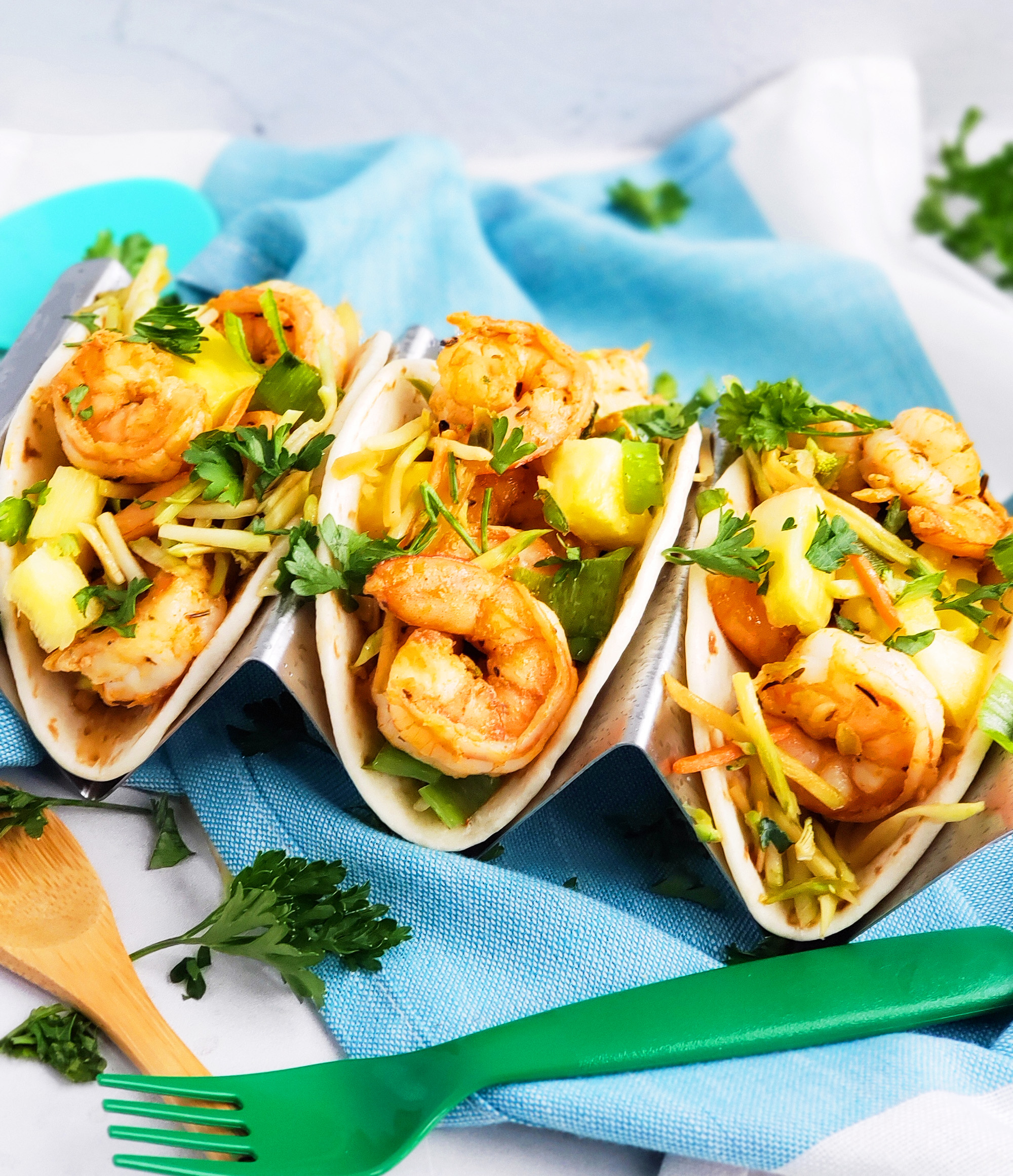 These Spicy Jerk Shrimp Mini Tacos are loaded with so much flavor and super easy to make! These street tacos are piled high with marinated slaw, jerk shrimp, pineapple, and green onions. Littleeatsandthings.com