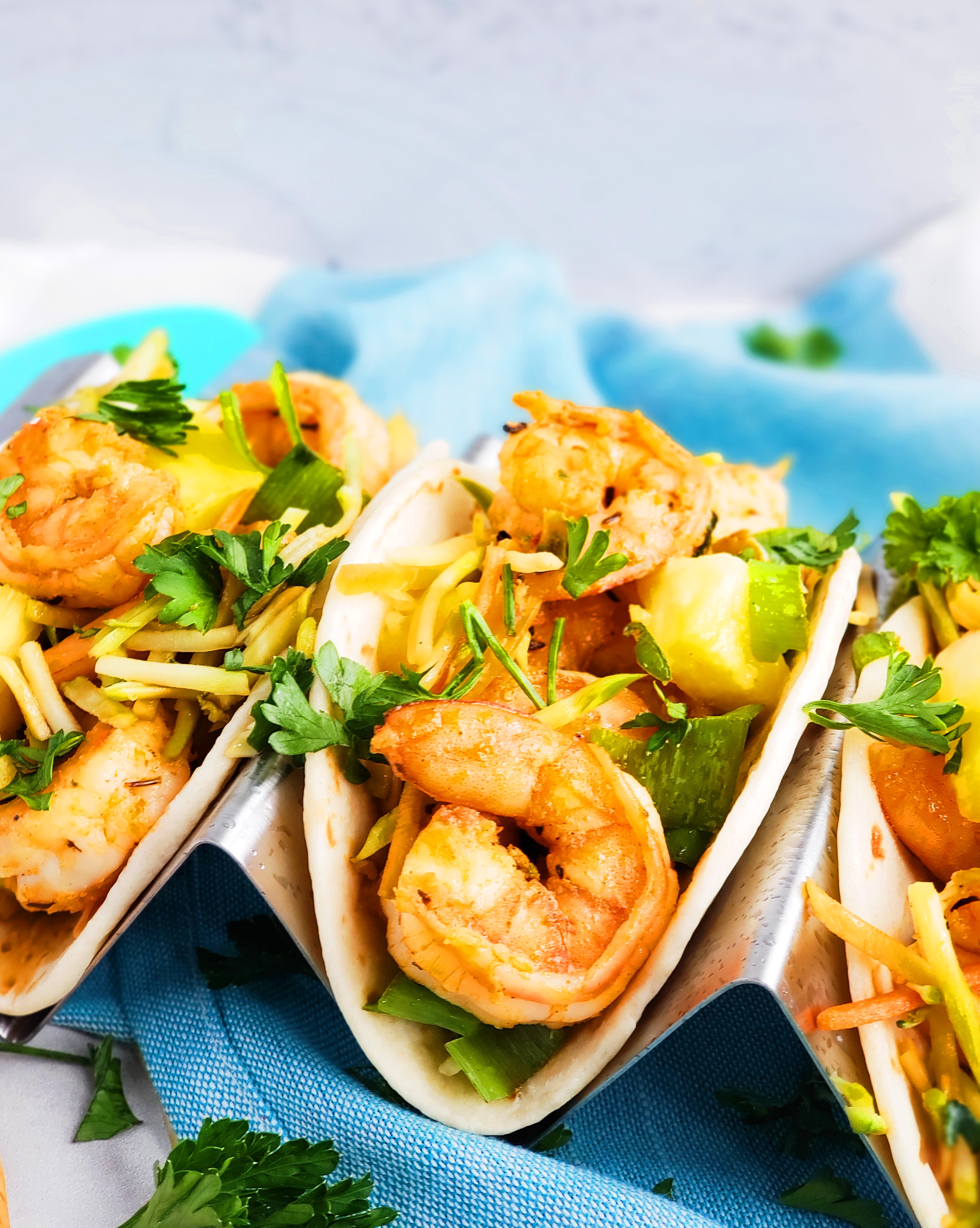 These Spicy Jerk Shrimp Mini Tacos are loaded with so much flavor and super easy to make! These street tacos are piled high with marinated slaw, jerk shrimp, pineapple, and green onions. Littleeatsandthings.com