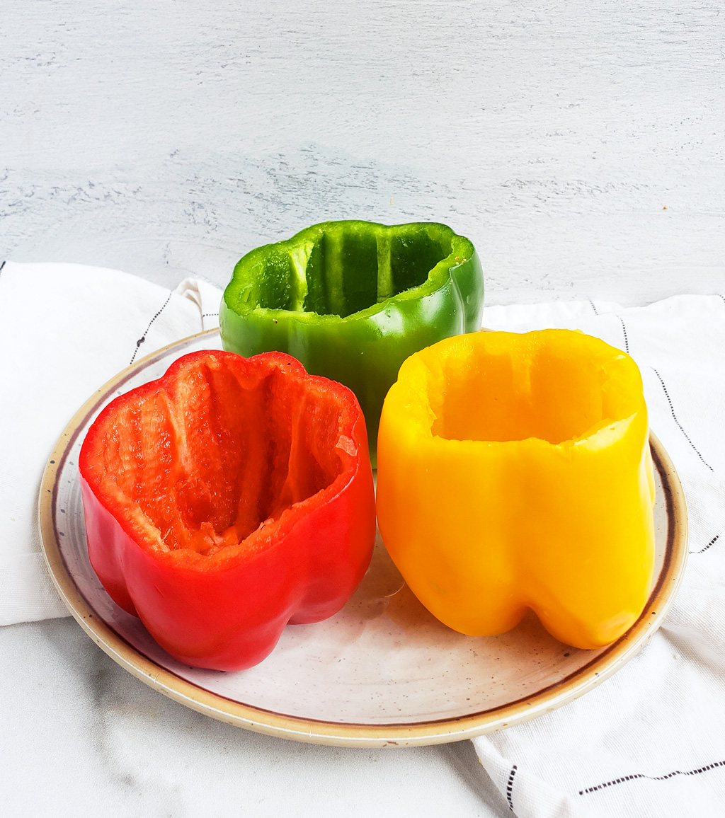 These Spooky Halloween Jack-O-Lantern Bell Peppers are the perfect, nutritious treat for a night of fun! It’s a great way to encourage your kids to eat more veggies!  beautifuleatsandthings.com