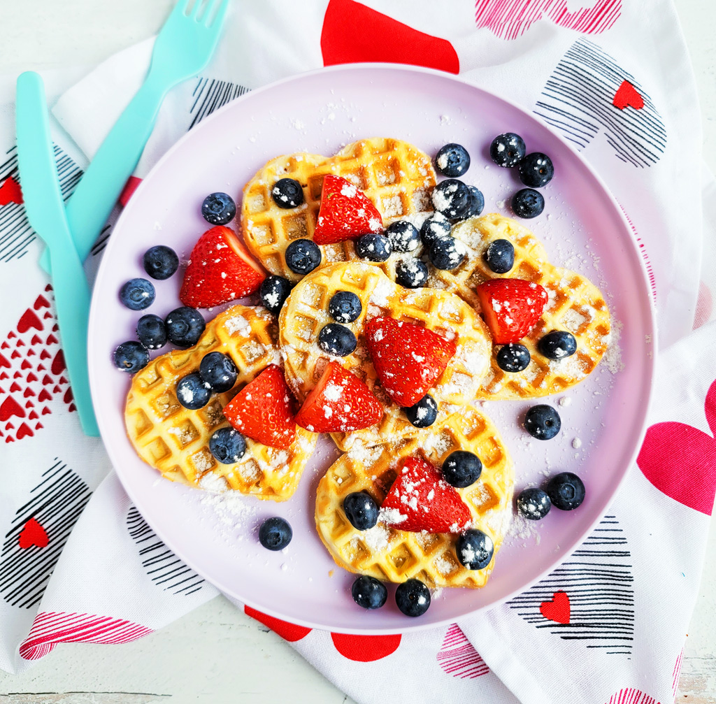 These Berry Yummy Mini Heart Waffles make the perfect Valentine’s Day breakfast! So light and airy… and topped with delicious blueberries and strawberries. littleeatsandthings.com