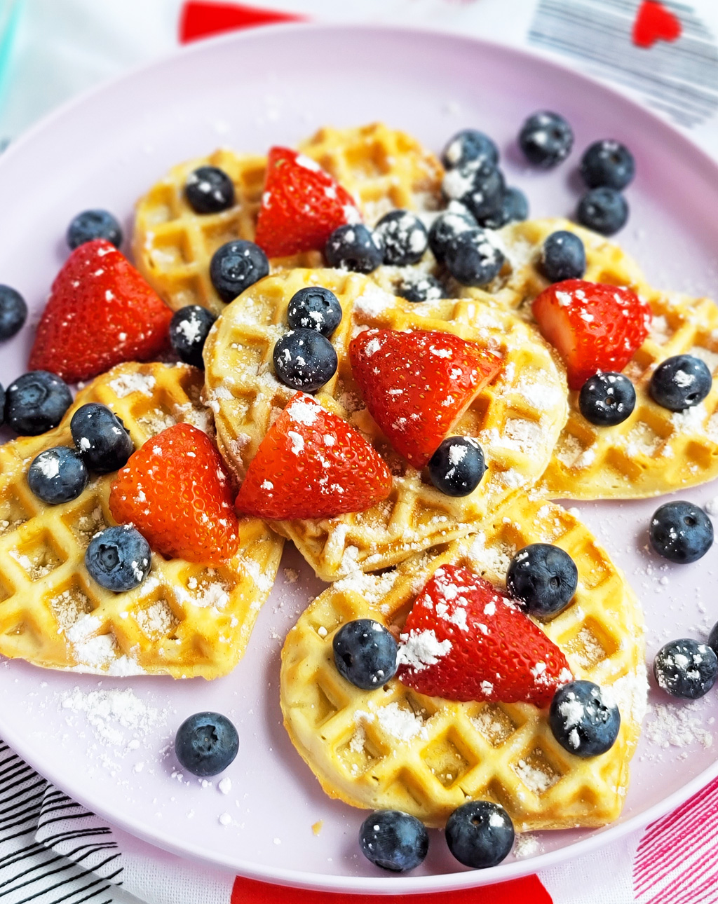 These Berry Yummy Mini Heart Waffles make the perfect Valentine’s Day breakfast! So light and airy… and topped with delicious blueberries and strawberries. littleeatsandthings.com