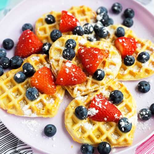 These Berry Yummy Mini Heart Waffles make the perfect Valentine’s Day breakfast! So light and airy… and topped with delicious blueberries and strawberries. littleeatsandthings.com