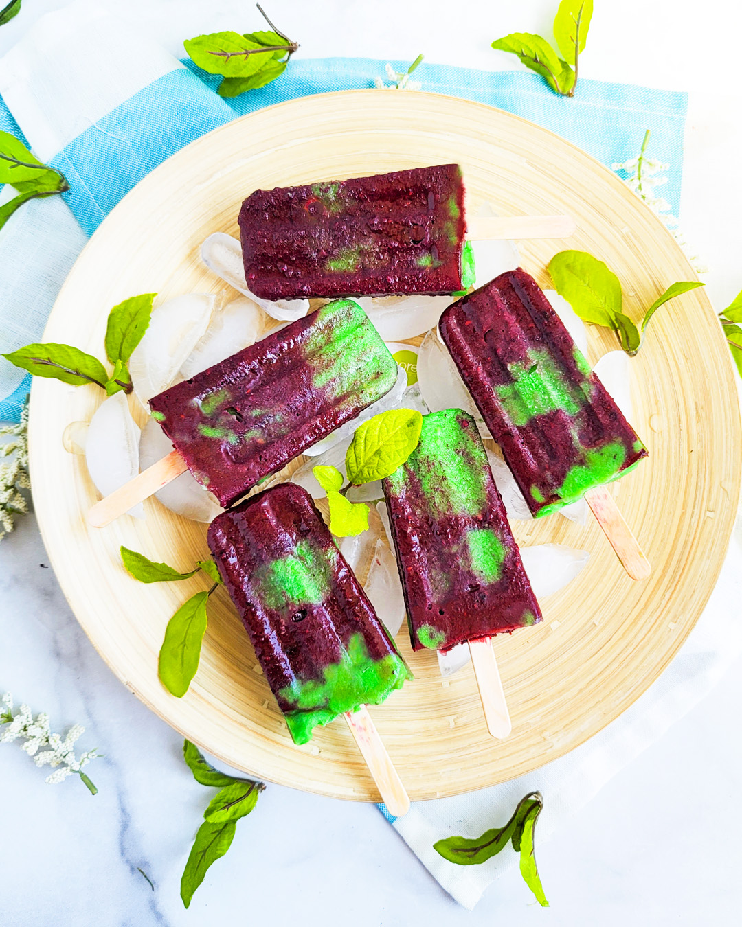 Celebrate Earth Day with these fruity Berry Banana Avocado Earth Day Popsicles made with blackberries, blueberries, banana, and avocado littleeatsandthings.com