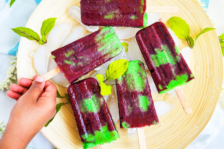 Celebrate Earth Day with these fruity Berry Banana Avocado Earth Day Popsicles made with blackberries, blueberries, banana, and avocado littleeatsandthings.com