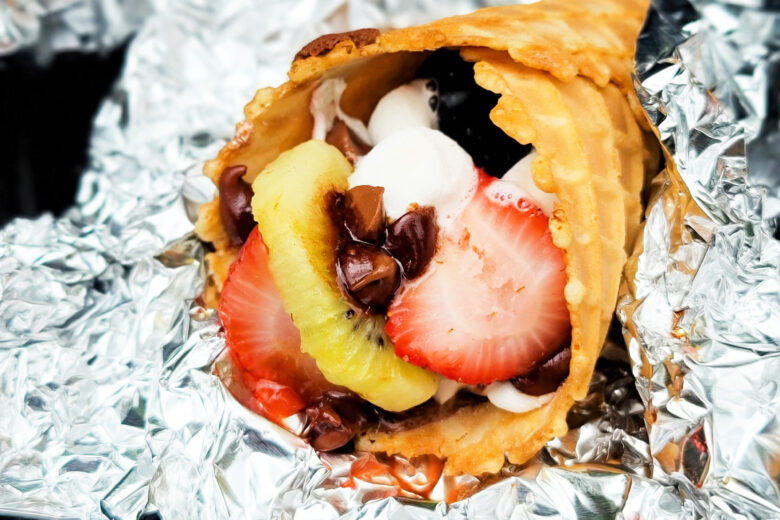 fire up the grill and make these delicious Fruity Campfire Cones made with waffle cones stuffed with marshmallows, chocolate chips, strawberry, kiwi, and blueberries littleeatsandthings.com