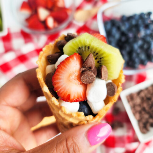 fire up the grill and make these delicious Fruity Campfire Cones made with waffle cones stuffed with marshmallows, chocolate chips, strawberry, kiwi, and blueberries littleeatsandthings.com