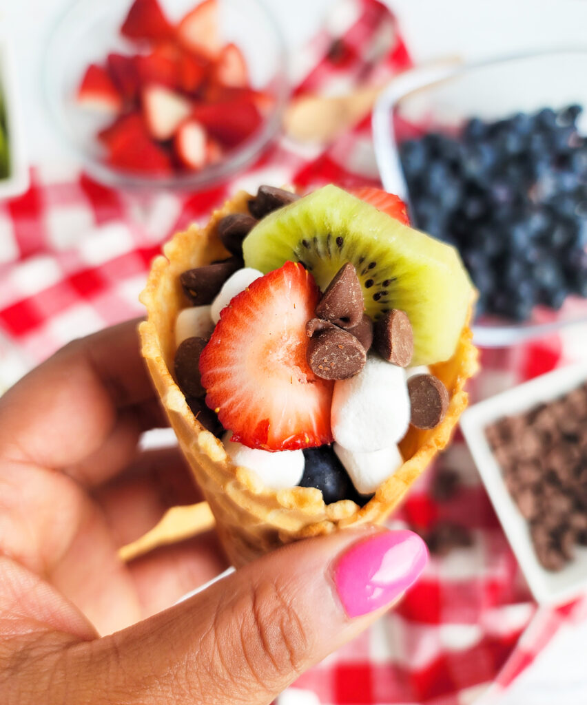 fire up the grill and make these delicious Fruity Campfire Cones made with waffle cones stuffed with marshmallows, chocolate chips, strawberry, kiwi, and blueberries littleeatsandthings.com