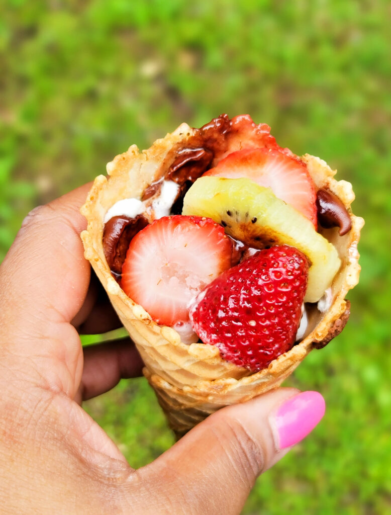 fire up the grill and make these delicious Fruity Campfire Cones made with waffle cones stuffed with marshmallows, chocolate chips, strawberry, kiwi, and blueberries littleeatsandthings.com