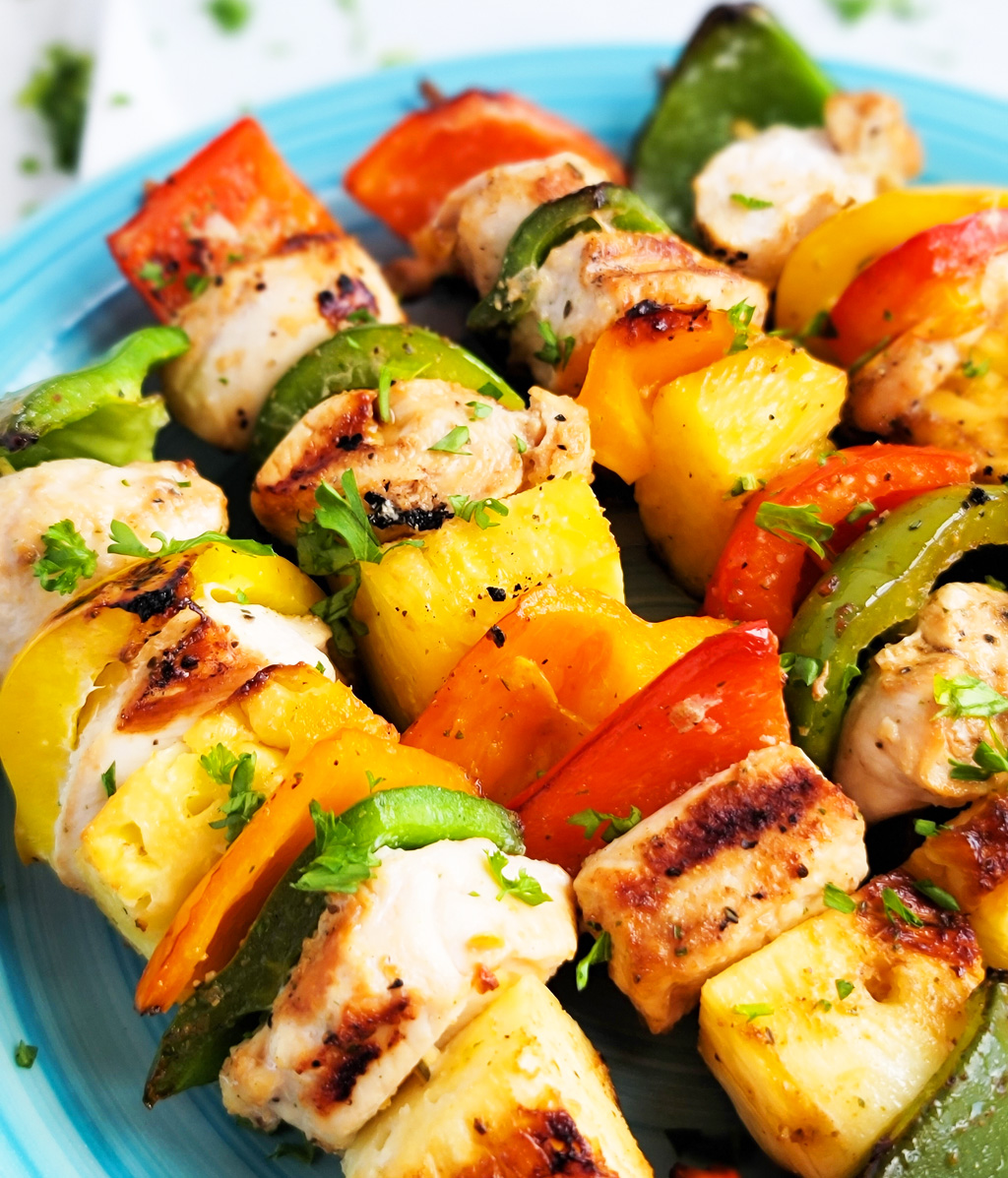 Make this Memorial Day weekend the best one yet with these super fun Hawaiian Grilled Chicken & Pineapple Kabobs made with red bell peppers, green bell peppers, yellow bell peppers and orange bell peppers, pineapples, and chicken. littleeatsandthings.com