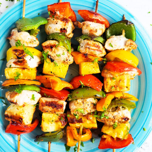 Make this Memorial Day weekend the best one yet with these super fun Hawaiian Grilled Chicken & Pineapple Kabobs made with red bell peppers, green bell peppers, yellow bell peppers and orange bell peppers, pineapples, and chicken. littleeatsandthings.com