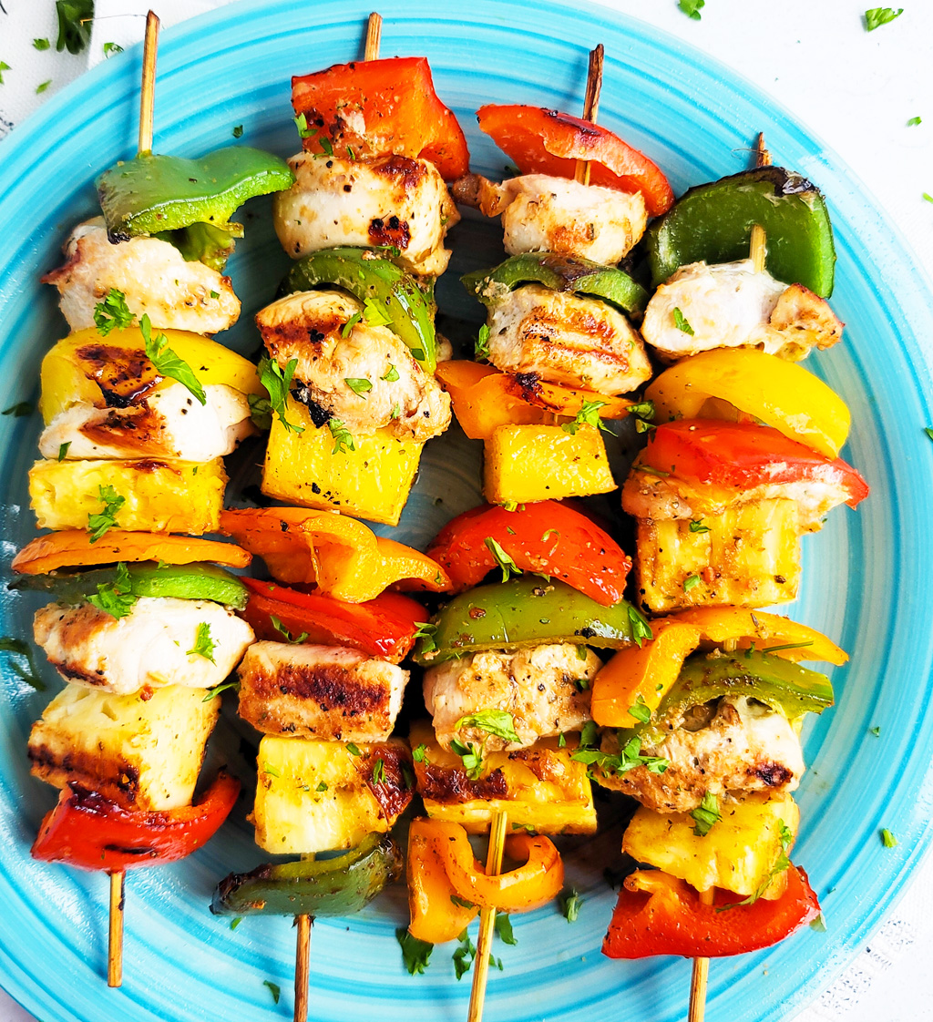 Make this Memorial Day weekend the best one yet with these super fun Hawaiian Grilled Chicken & Pineapple Kabobs made with red bell peppers, green bell peppers, yellow bell peppers and orange bell peppers, pineapples, and chicken. littleeatsandthings.com