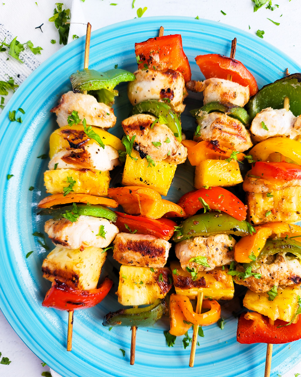 Make this Memorial Day weekend the best one yet with these super fun Hawaiian Grilled Chicken & Pineapple Kabobs made with red bell peppers, green bell peppers, yellow bell peppers and orange bell peppers, pineapples, and chicken. littleeatsandthings.com